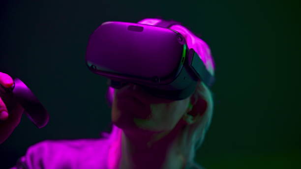 istock Impressed man experiencing VR headset videogame neon background. Future concept 1456936042