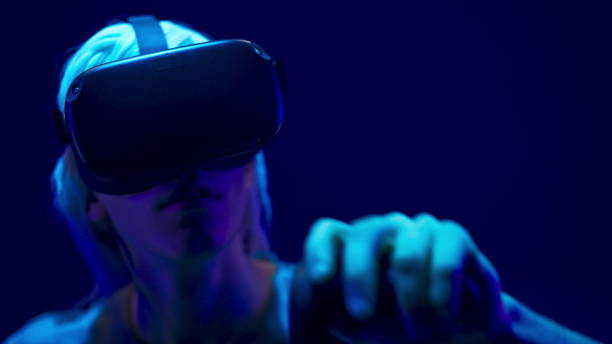 istock Serious man VR glasses using controllers in videogame closeup. Future concept 1456936092
