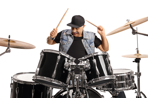 Mature male musician playing drums isolated on white background