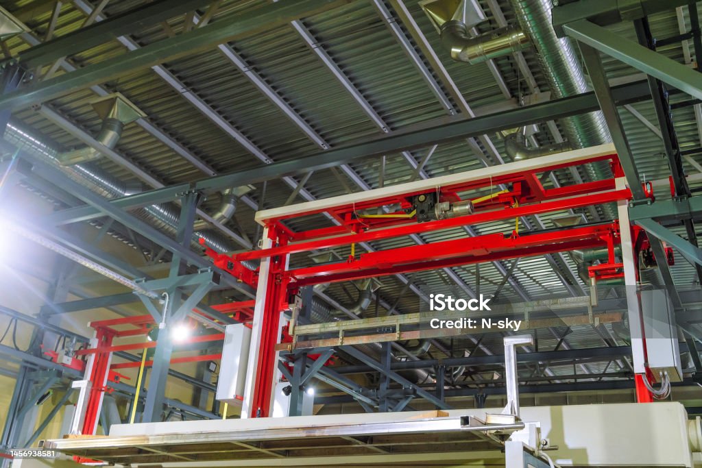 Lifting equipment of metal products from bath of electrochemical chrome plating. Fragment of a galvanic line. Chemical Stock Photo