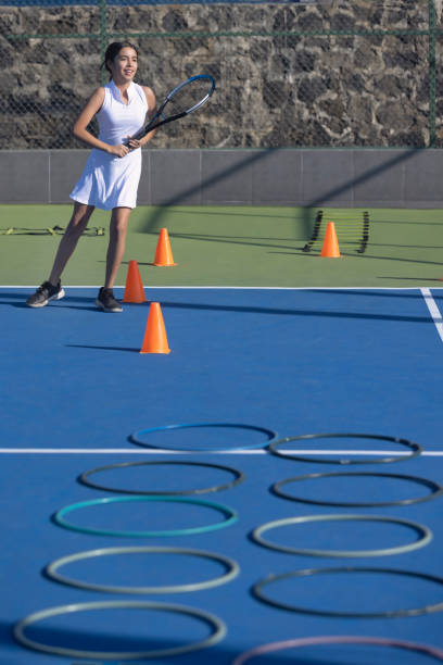 istock Girl doing an obstacle exercise in tennis 1456942589