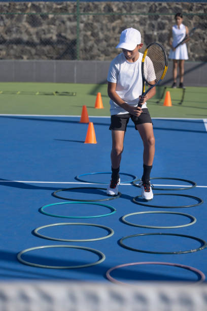 istock Boy doing an obstacle exercise in tennis 1456942646