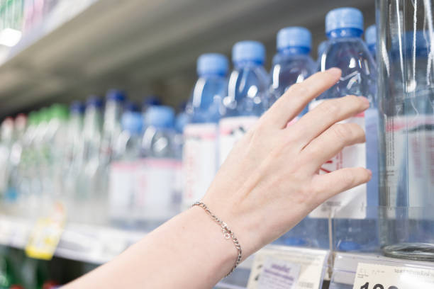 istock choosing good mineral water in a shop. 1456944636