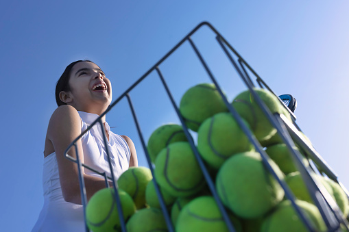 happy girl adding balls to the basket
