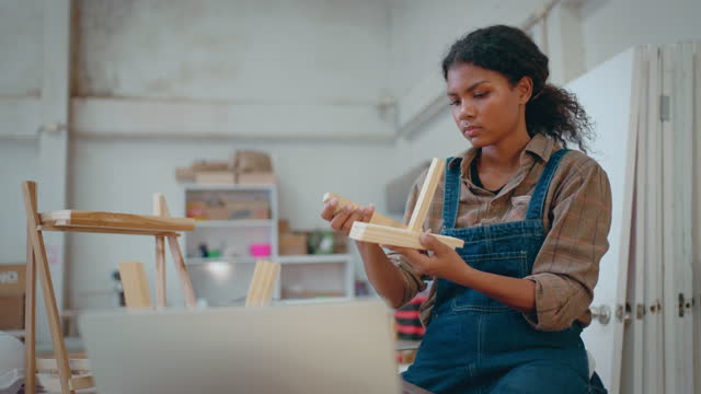 Young woman carpenter in workshop.