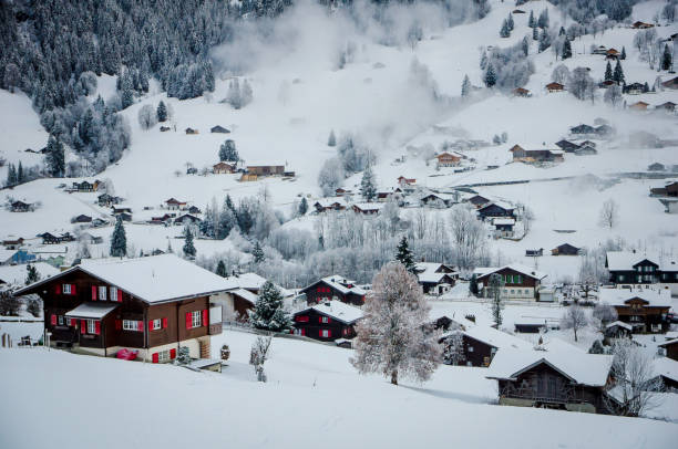 Aerial view snowy mountain peaks above traditional wooden chalet Alps in  Grindelwald, Switzerland Aerial view snowy mountain peaks above traditional wooden chalet Alps in  Grindelwald, Switzerland jungfrau stock pictures, royalty-free photos & images