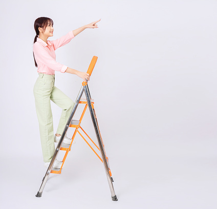 Image of young Asian woman clamb up to the ladder