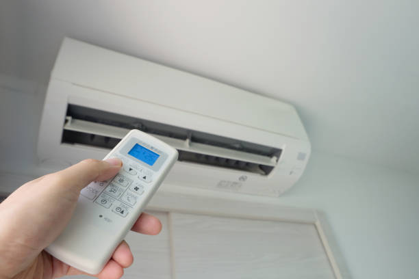 istock Man's hand using remote control open The air conditioner is cooled to 25 degrees Celsius in his bedroom. Health concepts and energy savings 1456960168