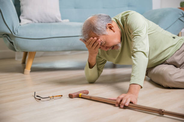 istock Older senior man headache lying on the floor after falling 1456961425