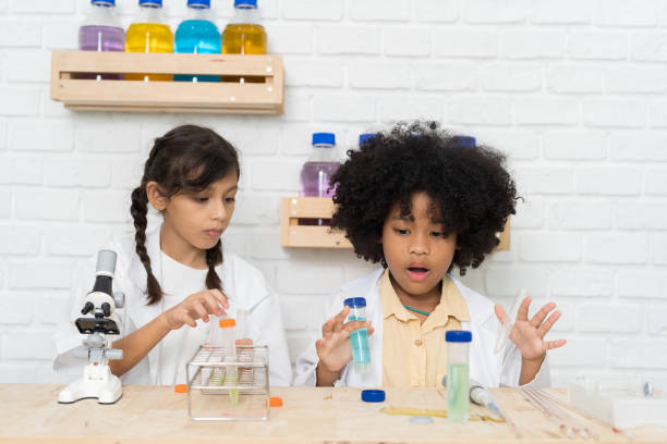 istock Two child girl scientists learning science and doing analysis with microscope in the laboratory at school. Science and education, researcher and discovery concept 1456963078
