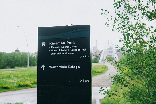 A signboard of Walterdale Bridge and Kinsmen Park on the road in Edmonton, Alberta, Canada. Focus on the sign.