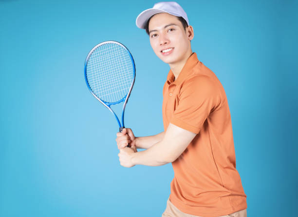 istock Image of young Asian man holding tennis racket 1456965961