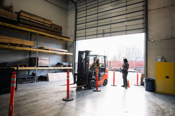 istock Woman Operating Warehouse Forklift Drives Through Open Door 1456969197
