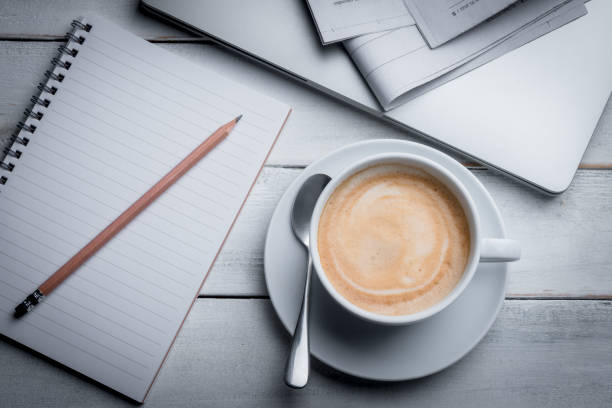 istock Morning coffee with newspaper, notebook, pencil and laptop. 1456973599