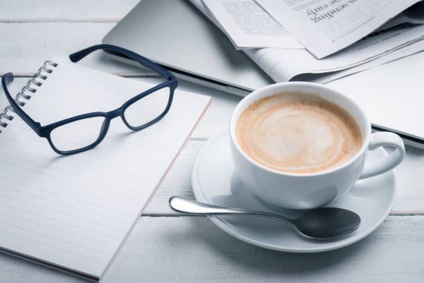 istock Morning coffee with newspaper, notebook, pencil and laptop. 1456973601