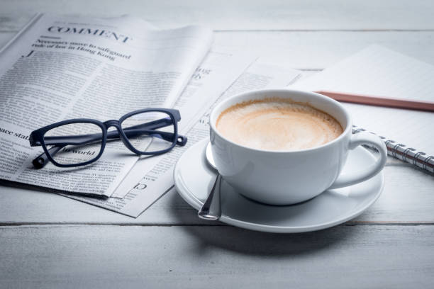 istock Morning coffee with newspaper, notebook, pencil and laptop. 1456973604