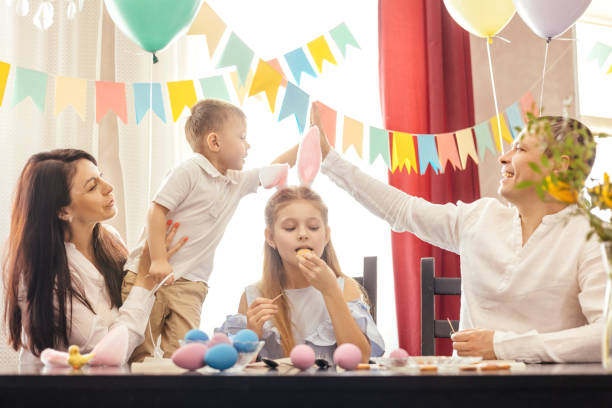 istock A friendly family paints Easter eggs and laughs. 1456984498