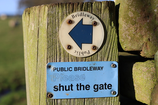 Public bridleway footpath sign on a gatepost