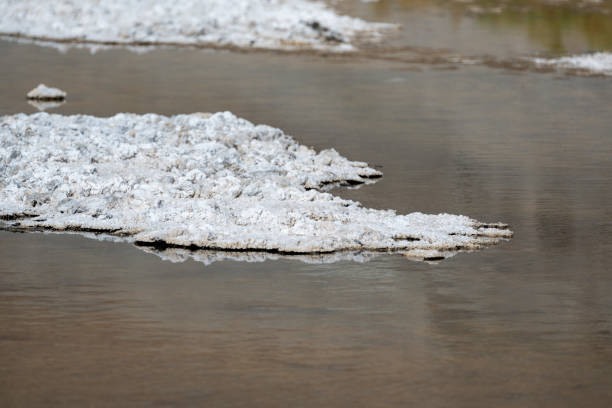 Dry flat and wet salt ground at the Badwater Basin at Death Valley National Park, California, USA. Seen a hot summer day.