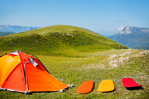Tent with sleeping mats in mountain camping
