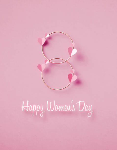 happy women's day nachricht unter nummer acht gebildet von rosa herzformen und goldfarbenen kreisen auf rosa hintergrund - märz fotos stock-fotos und bilder