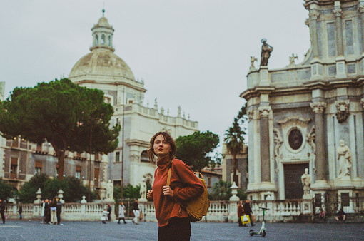 Backpacker  young Caucasian woman exploring Catania old town