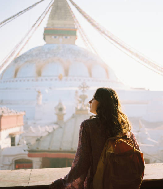 femme debout sur le fond du stupa de bouddha à katmandou - patan photos et images de collection