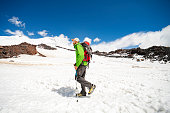 Young adult man hiking in snowy mountain