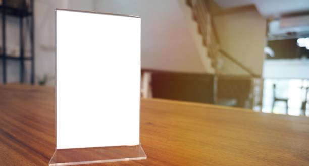 istock Mock up Menu frame standing on wood table in Bar restaurant cafe. space for text. 1456998505