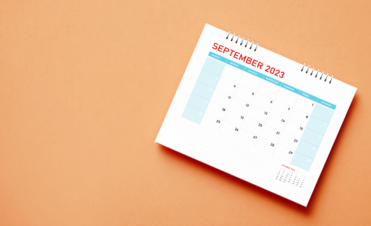 September 2023 calendar on orange background. Directly above. Horizontal composition with copy space. Calendar and reminder concept.