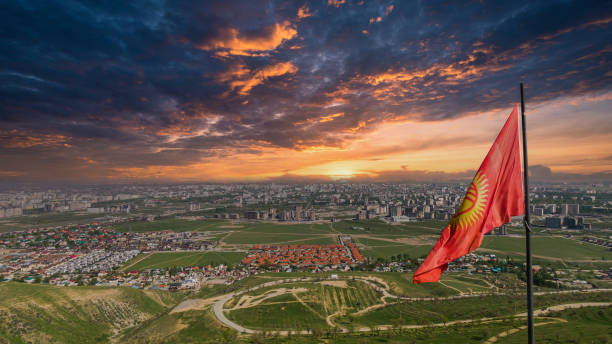 istock Flagpole with waving Kyrgyzstan flag and dramatic sky 1457001085