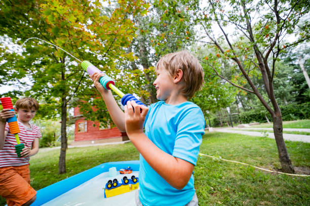 istock Two brothers playing with toy water guns at back yard 1457002289