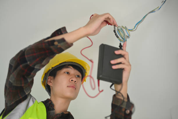 Electrician man working with cable mounting and assembling new wiring.