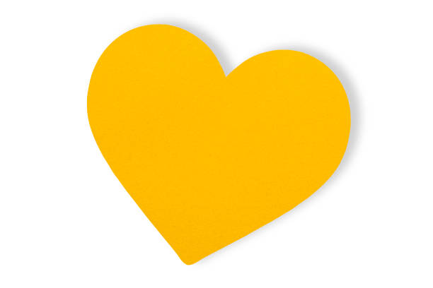 istock yellow paper Cut into a heart shape isolated on a white background, Valentine's Day celebration. 1457002944