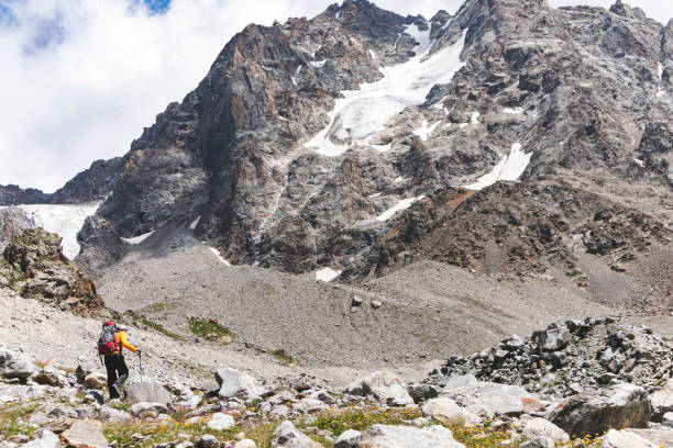 istock Young adult man hiking in mountains alone 1457003086