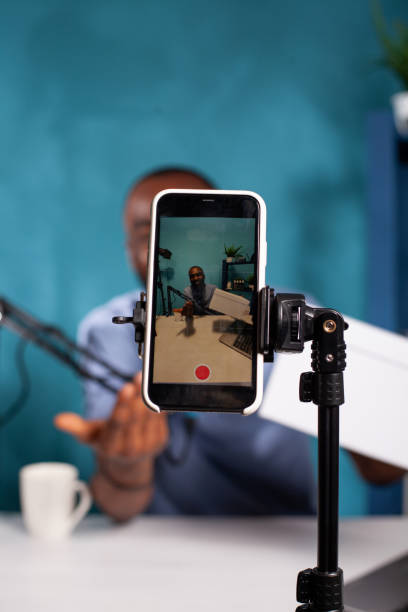 istock Selective focus on mobile phone recording influencer hosting online giveaway holding product box 1457004591
