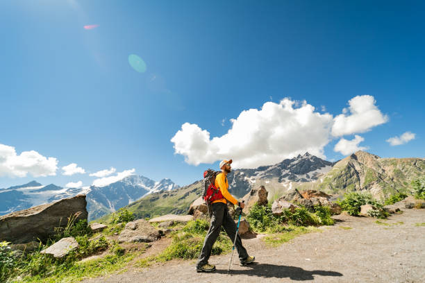 Young adult man hiking in mountains alone