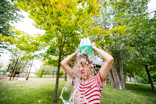 Boy playing with water at back yard (motion)