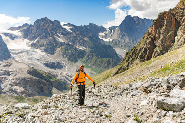istock Young adult man hiking in mountains alone 1457005505