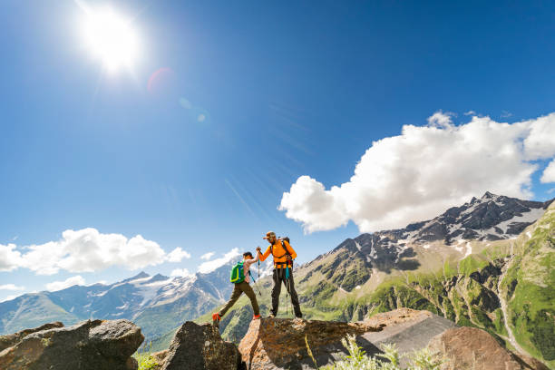 istock Father and son hiking in mountains 1457008990