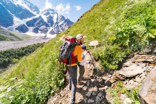 istock Father and son trekking in mountains 1457009533