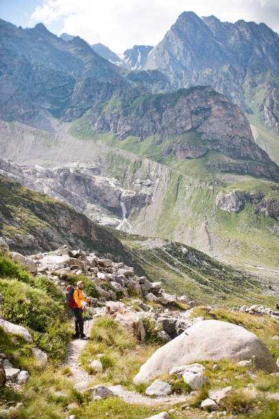 istock Young adult man hiking in mountains alone 1457012368