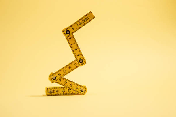 istock tape measure on the yellow background with copy space 1457012413