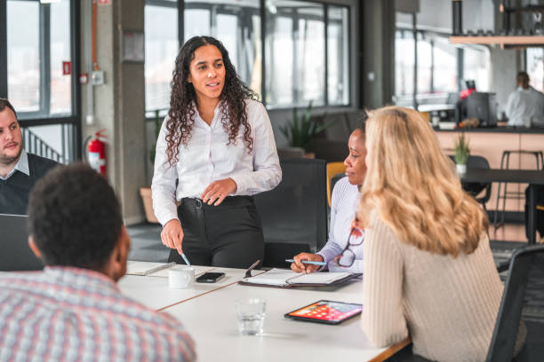 istock Marketing Agency Female Manager Exchanges Ideas with Team Members 1457012708