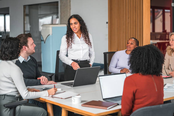 istock Good Looking Latin Explaining Ideas To Her Team Members 1457012715