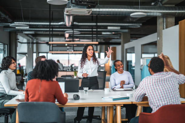 istock Group Of Individuals From Various Ethnicities Are Exchanging Ideas and Raise their Hands 1457012754