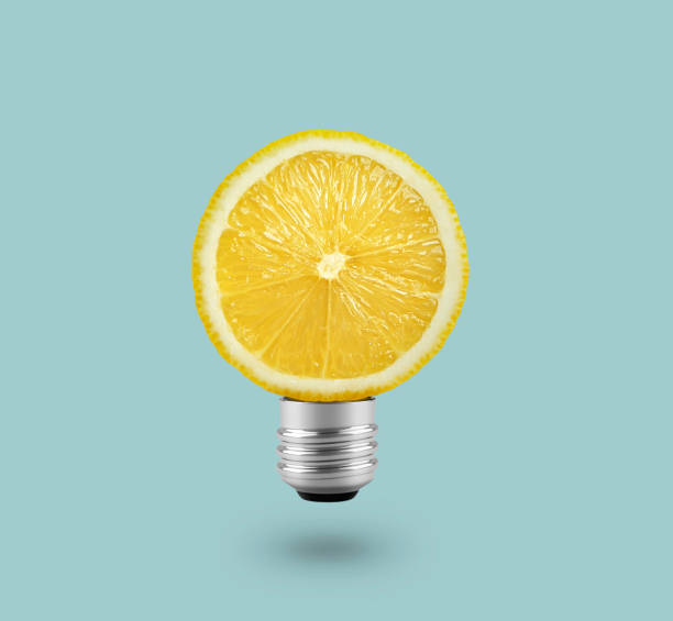 istock Yellow Lemon light bulb on bright blue background. Summer fun concept 1457016639