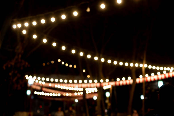 istock Christmas street light with hanging light bulbs 1457017255