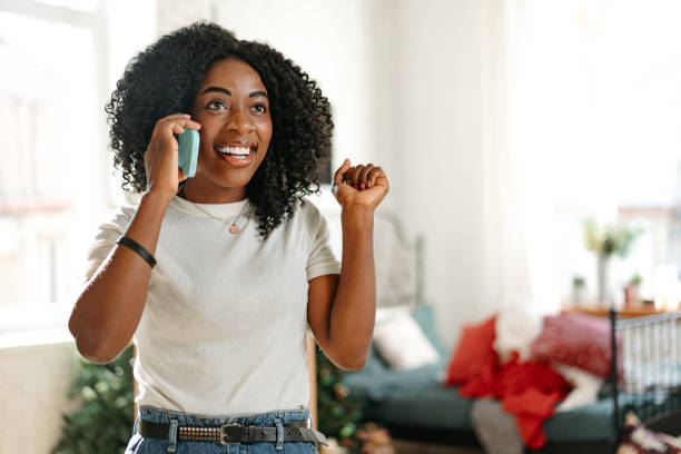 istock African young woman talking on a mobile phone at home 1457018649