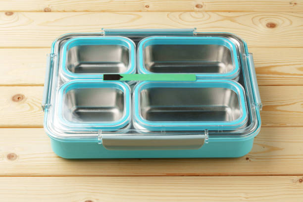 istock Metal lunch box with compartments on wooden background 1457019363